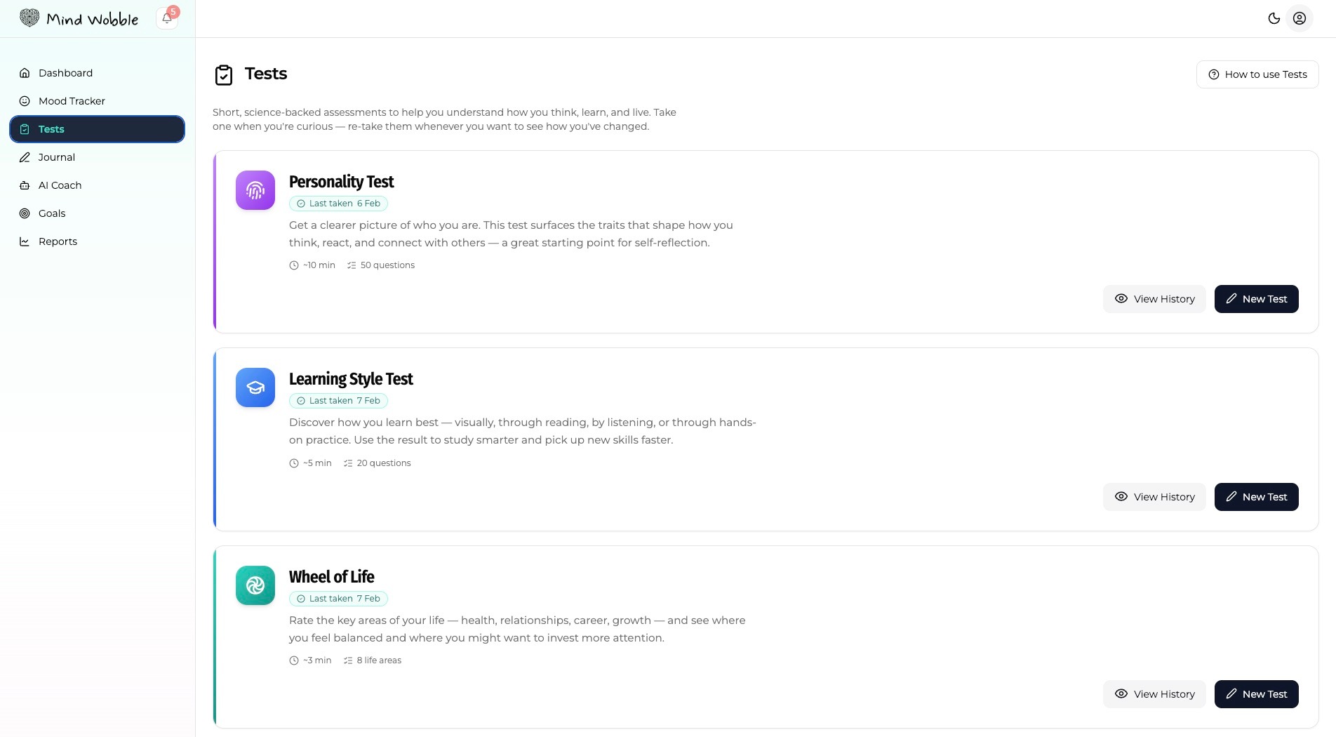 Show the Mind Wobble Tests page with Personality Test, Learning Style Test, Wheel of Life, and Values Test cards visible, including take test and view history actions.